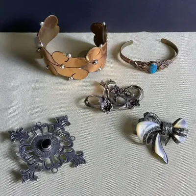 Assorted Copper Cuffs And Sterling Brooches 