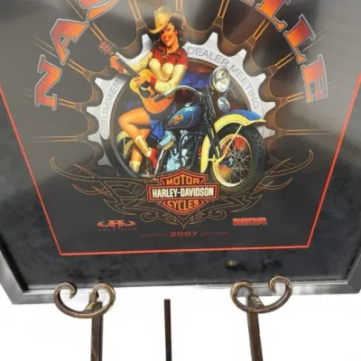 Framed Harley-Davidson 2007 Summer Dealer Meeting Nashville limited edition print, featuring a pin-up style illustration of a woman with...