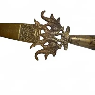 Vintage brass letter opener featuring an ornate, openwork hilt with stylized dragon or sea creature motifs and an engraved handle.