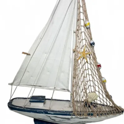 Decorative wooden model sailboat with a distressed blue and white finish, featuring a fabric sail, a fishing net adorned with a starfish...