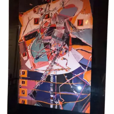 Framed abstract mixed media artwork featuring geometric shapes and vibrant colors, presented in a wide black frame.