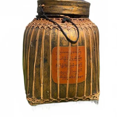 Vintage Southeast Asian woven bamboo and lacquer storage jar, featuring a fitted lid, cord handle, and a central panel with hand-painted...