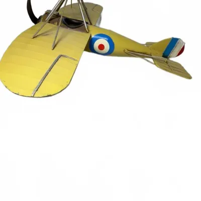 Vintage-style sheet metal model of a World War I-era biplane, featuring a yellow paint finish with Royal Air Force roundels.