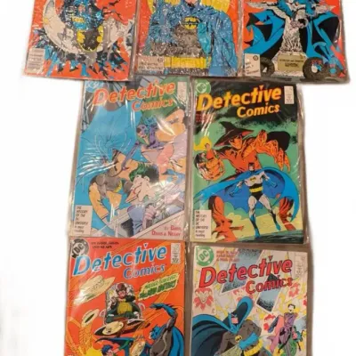 Collection of seven vintage DC Detective Comics featuring Batman, individually bagged and boarded, dating from the late 1980s.