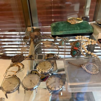 Assortment of vintage jewelry and watches, including several silver-tone wristwatches, a pearl necklace, turquoise rings, and a gold-tone...