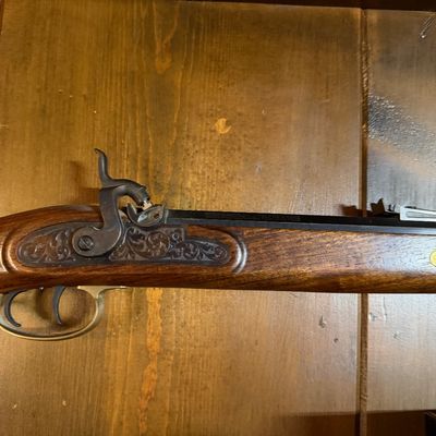 Sale Photo Thumbnail #101: Vintage percussion cap muzzleloader rifle featuring an engraved lockplate, double set triggers, and a brass trigger guard.