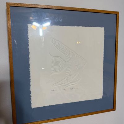 Framed embossed paper art print depicting an angelfish, signed and numbered 141/1000, presented in a wooden frame with a blue mat.
