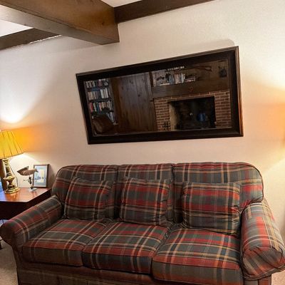 Sale Photo Thumbnail #137: Three-cushion sofa upholstered in a rustic red, green, and blue plaid fabric, complete with three matching throw pillows.