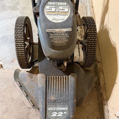 Sale Photo Thumbnail #273: Craftsman 5.5 HorsePower Eager-1 wheeled string weed trimmer featuring a 22-inch cutting width and large rear wheels.