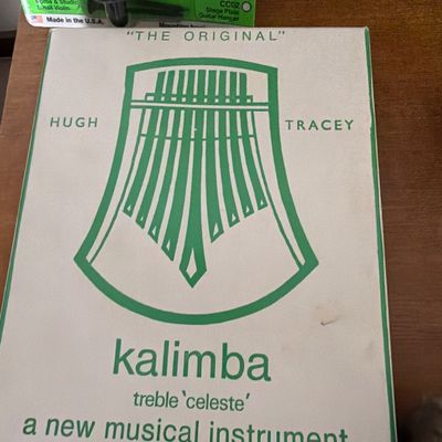 Sale Photo Thumbnail #185: Vintage Hugh Tracey treble 'celeste' kalimba in its original green and white cardboard box.