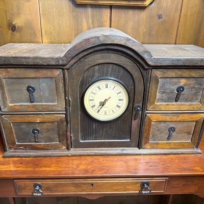 Vintage wooden tabletop jewelry box or organizer featuring a central quartz clock with Roman numerals, flanked by four small drawers with...