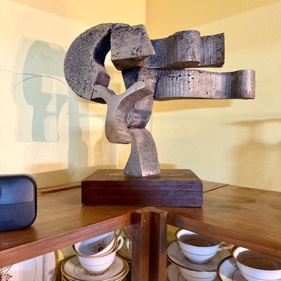 Mid-century modern abstract metal tabletop sculpture mounted on a square wooden base.