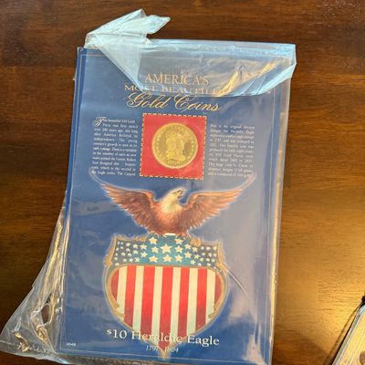 Sale Photo Thumbnail #230: "America's Most Beautiful Gold Coins" collector's set featuring a replica or commemorative $10 Heraldic Eagle gold coin, sealed in its original plastic packaging.