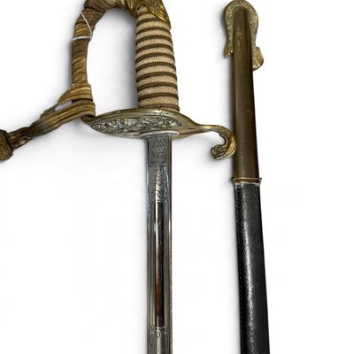 Vintage navy ceremonial officer's sword with an etched steel blade, brass guard, wire-wrapped grip, sword knot, and matching scabbard.