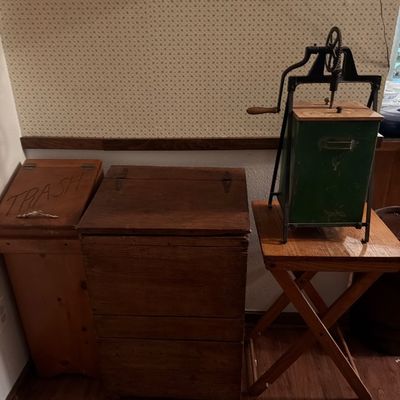 Sale Photo Thumbnail #143: Vintage wooden trash bin, rustic wooden chest, and an antique hand-crank butter churn on a folding wooden stand.