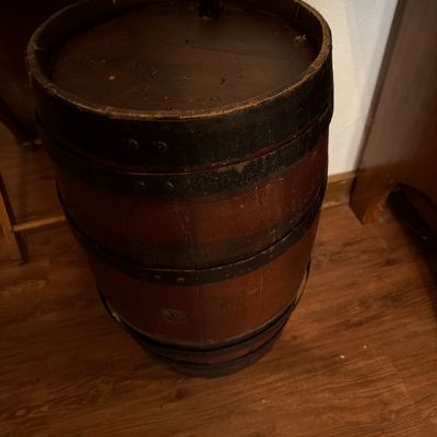 Sale Photo Thumbnail #142: Vintage wooden barrel with dark metal bands, showing a rustic, weathered finish.