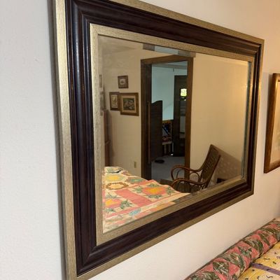 Large rectangular wall mirror featuring a wide, multi-tiered frame with dark wood and textured silver-gilt finishes.