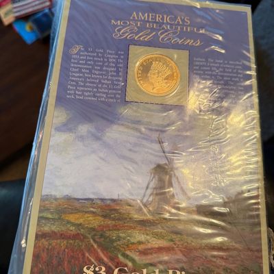 Sale Photo Thumbnail #221: America's Most Beautiful Gold Coins commemorative display card featuring a replica or genuine $3 Gold Piece (1854-1889), sealed in protective plastic packaging.