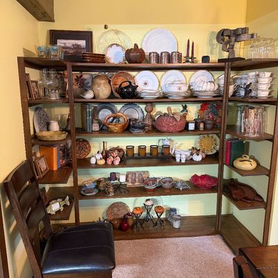 Sale Photo Thumbnail #111: Large wooden shelving unit filled with vintage home decor, pottery, glassware, ceramic dish sets, and decorative items.
