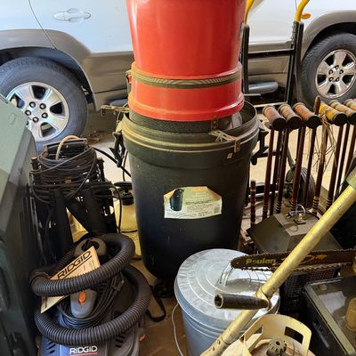 Sale Photo Thumbnail #279: Collection of garage and yard items including a Ridgid portable shop vac, trash cans, a propane tank, and a set of croquet mallets.