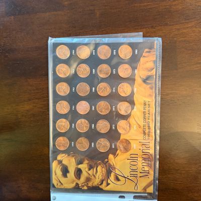 Sale Photo Thumbnail #216: Lincoln Memorial complete copper penny year set spanning 1959 to 1982, housed in a protective plastic sleeve.