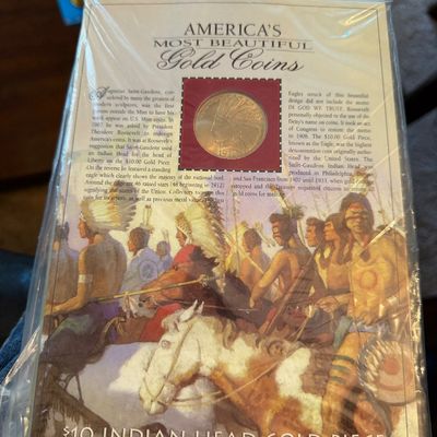 Sale Photo Thumbnail #219: America's Most Beautiful Gold Coins display card featuring a replica or genuine $10 Indian Head Gold Piece, dated 1907-1933, preserved in its original plastic packaging.
