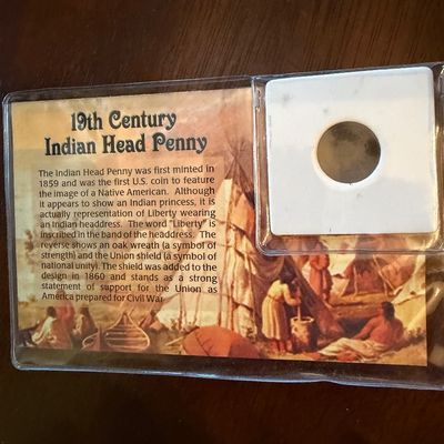 Sale Photo Thumbnail #248: Collectible 19th-century Indian Head Penny housed in a protective display sleeve with an educational information card.