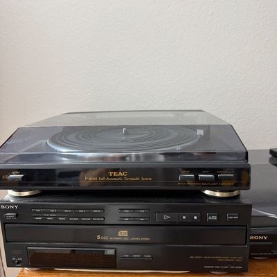 Sale Photo Thumbnail #177: TEAC P-A688 full-automatic turntable system stacked on top of a Sony 5-disc automatic disc loading system compact disc player.