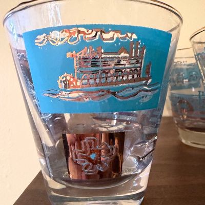 Sale Photo Thumbnail #114: Vintage lowball glass featuring a blue and metallic copper steamboat motif, mid-century modern style.