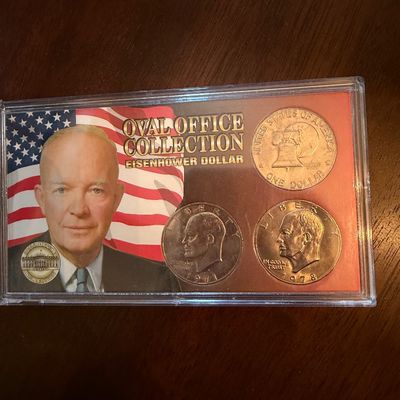 Sale Photo Thumbnail #250: Oval Office Collection Eisenhower Dollar set featuring three coins in a protective plastic display case.