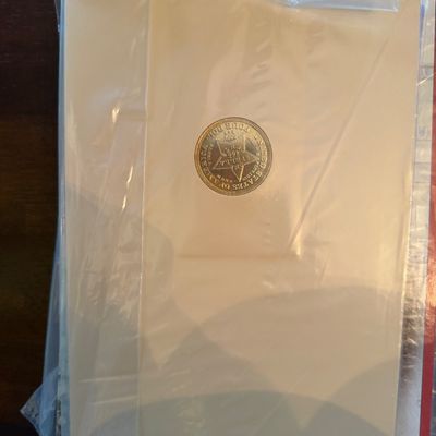 Sale Photo Thumbnail #261: The American Historic Society commemorative coin set, featuring a gold-colored replica coin in its original protective plastic sleeve.