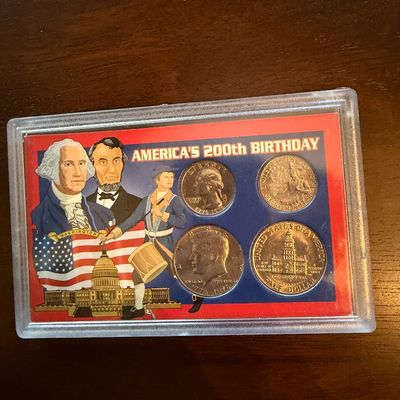 Sale Photo Thumbnail #239: America's 200th Birthday bicentennial coin set, featuring a 1776-1976 quarter and half dollar housed in a decorative plastic display case.