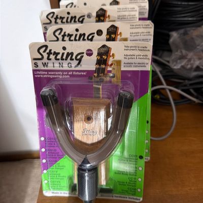 Sale Photo Thumbnail #184: A row of String Swing wall-mount guitar hangers in their original retail packaging.
