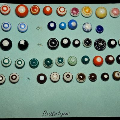 Sale Photo Thumbnail #117: A Collection of Vintage Glass Bullseye Game Buttons and Marbles on Handwritten Display Card