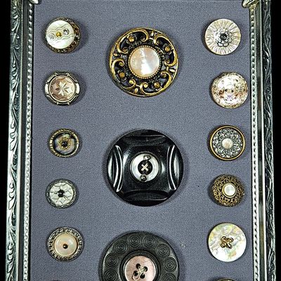 Sale Photo Thumbnail #282: An Assortment of Fifteen Antique and Vintage Mother of Pearl and Mixed Material Buttons in a Metal Tabletop Frame