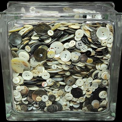 Sale Photo Thumbnail #338: A Collection of Vintage Mother-of-Pearl and Composition Buttons in a Glass Block Jar