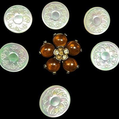 Sale Photo Thumbnail #382: A Group of Carved Mother of Pearl Buttons and a Faux Amber Floral Brooch