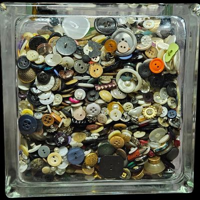 Sale Photo Thumbnail #343: An Assortment of Vintage Sewing Buttons and Notions in a Glass Block Container