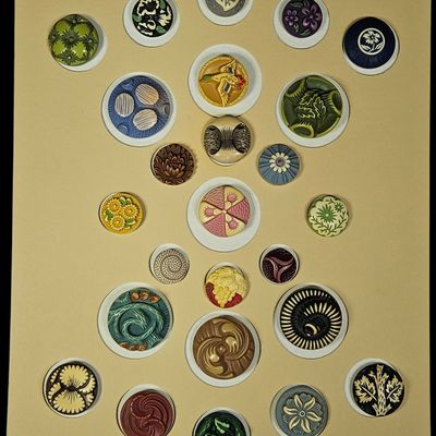 A Collection of Twenty-Four Celluloid and Early Plastic Buttons on Display Card