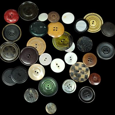 Sale Photo Thumbnail #380: A Collection of Approximately 35 Assorted Vintage Buttons in Celluloid Mother of Pearl and Wood