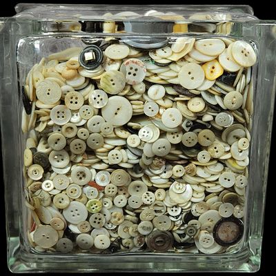 Sale Photo Thumbnail #336: A Large Collection of Natural Mother of Pearl and Shell Buttons in a Glass Block Container