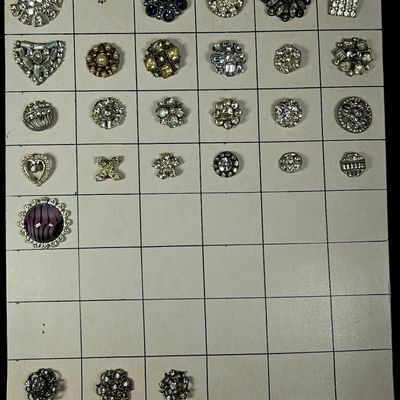 An Assortment of Vintage Costume Jewelry Components Including Rhinestone Buttons and Dress Clips