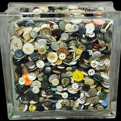 Sale Photo Thumbnail #339: A Collection of Assorted Sewing Buttons in an Architectural Glass Block Storage Jar