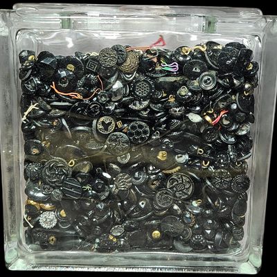 Sale Photo Thumbnail #341: A Collection of Assorted Black Glass and Composition Buttons in a Glass Block Container