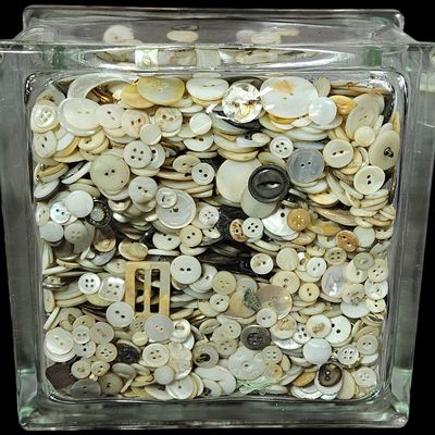 Sale Photo Thumbnail #337: A Collection of Vintage Mother-of-Pearl and Shell Sewing Buttons in a Glass Building Block