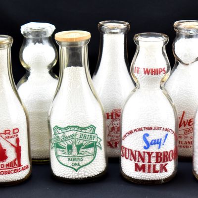 EIGHT OREGON GLASS DAIRY BOTTLES: QUART AND CREAM-TOP BOTTLES