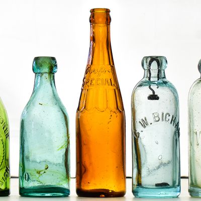 ASSORTED COLOR GLASS BOTTLES: WEST BROMWICH, C.W. BICHAM, C.W. EPLER, AND MORE