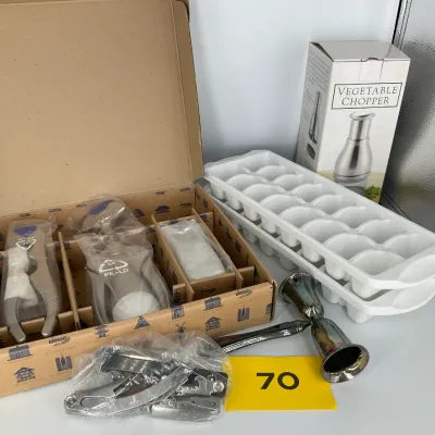 Sale Photo Thumbnail #18: Assorted kitchen gadgets including a boxed Biesse tool set, a boxed vegetable chopper, two white plastic ice cube trays, and a metal jigger.