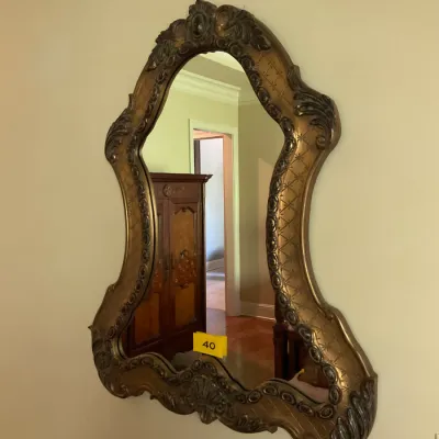 Sale Photo Thumbnail #16: Ornate vintage wall mirror featuring an asymmetrical, contoured gold-finished frame with carved scrollwork and crosshatch detailing.