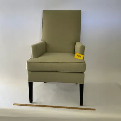 Sale Photo Thumbnail #26: Contemporary high-back armchair upholstered in a light olive green fabric, featuring dark tapered wooden legs.